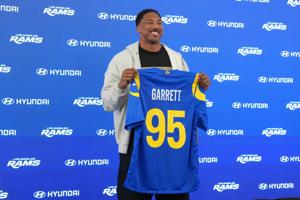 Los Angeles Rams defensive end Myles Garrett (95) poses with jersey at press conference at Rams Practice Facility.