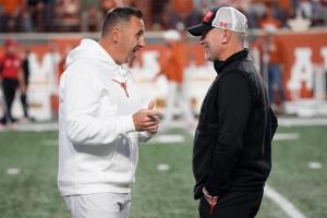 Nov 24, 2023; Austin, Texas, USA; Texas Longhorns head coach Steve Sarkisian talks with Texas Tech Red Raiders head coach Joey McGuire before the game at Darrell K Royal-Texas Memorial Stadium. Mandatory Credit: Scott Wachter-USA TODAY Sports