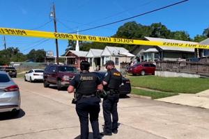 Police officers secure the scene where eight children were killed in a mass shooting in Shreveport