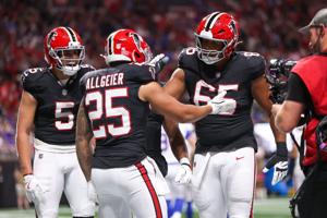 Atlanta Falcons running back Tyler Allgeier (25) reacts with guard Matthew Bergeron (65) after scoring a touchdown.