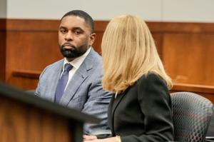 Former University of Michigan football coach Sherrone Moore talks with his attorney Ellen Michaels, in front of Judge J. Cedric