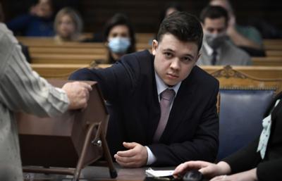 Kyle Rittenhouse pulls numbers of jurors out of a tumbler during his trial at the Kenosha County Courthouse on Tuesday, Nov. 16, 2021, in Kenosha, Wisconsin.
