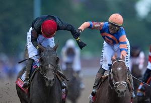 Golden Tempo, with Jose Ortiz up, left, gets congratulated by his brother, Irad, aboard Reneegade, after he wins the Kentucky