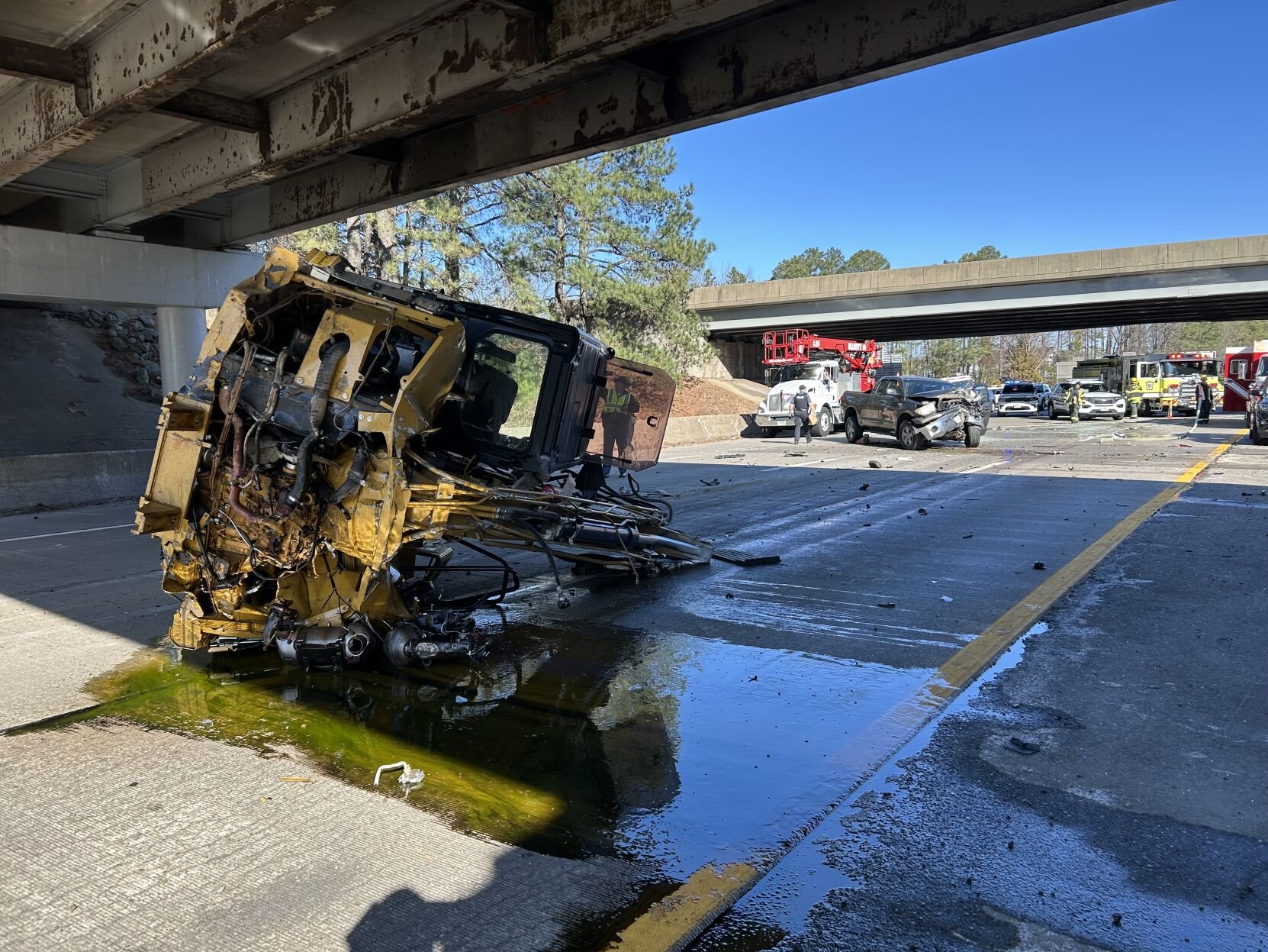 Overturned excavator under overpass