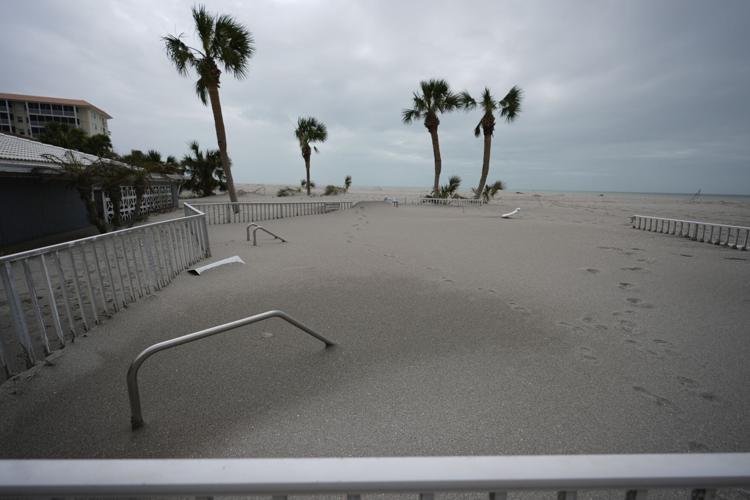 Storm surges bury Florida towns in mountains of sand