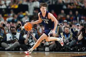 Apr 6, 2026; Indianapolis, IN, USA; UConn Huskies guard Braylon Mullins (24) dribbles the ball against the Michigan Wolverines during the first half in the national championship of the Final Four of the men's 2026 NCAA Tournament between the  and the