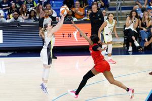 Dallas Wings guard Paige Bueckers (5) scores a three-point basket against Atlanta Dream forward Angel Reese (5) at College Park Center.
