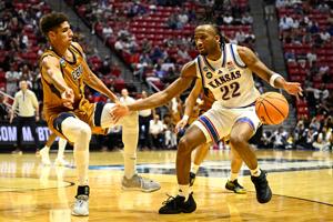 Mar 20, 2026; San Diego, CA, USA; Kansas Jayhawks guard Darryn Peterson (22) controls the ball against California Baptist Lancers forward Jonathan Griman (8) in the second half during a first round game of the men's 2026 NCAA Tournament at Viejas Are