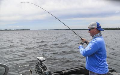 Catch Your Moment Foundation founder and cancer survivor Timmon Lund of Duluth plays a fish on Island Lake north of Duluth July 14, 2020. Catch Your Moment gives cancer patients the chance to go on fishing trips.