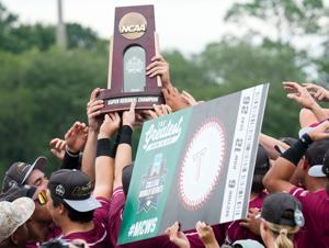 Troy University players hoist their Super Regional Championship trophy and their “ticket” to the College World Series after defeating Arkansas Little Rock during game two of their NCAA Baseball Super Regional on the Troy University campus in Troy, Al