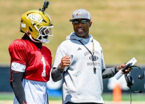 Head coach Eddie Robinson, Jr., works with quarterback Andrew Body (1) during an Alabama State University football scrimmage at ASU Stadium in Montgomery Ala., on Saturday August 16, 2025.