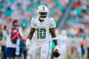 Dec 8, 2024; Miami Gardens, Florida, USA; Miami Dolphins wide receiver Tyreek Hill (10) looks on after making a catch against the New York Jets during the first quarter at Hard Rock Stadium. Mandatory Credit: Sam Navarro-Imagn Images