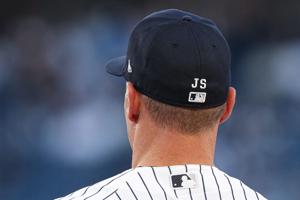 May 4, 2026; Bronx, New York, USA; New York Yankees wear "JS" stitched on their hats honoring radio play-by-play announcer John Sterling during the game against the Baltimore Orioles at Yankee Stadium. Mandatory Credit: Vincent Carchietta-Imagn Image