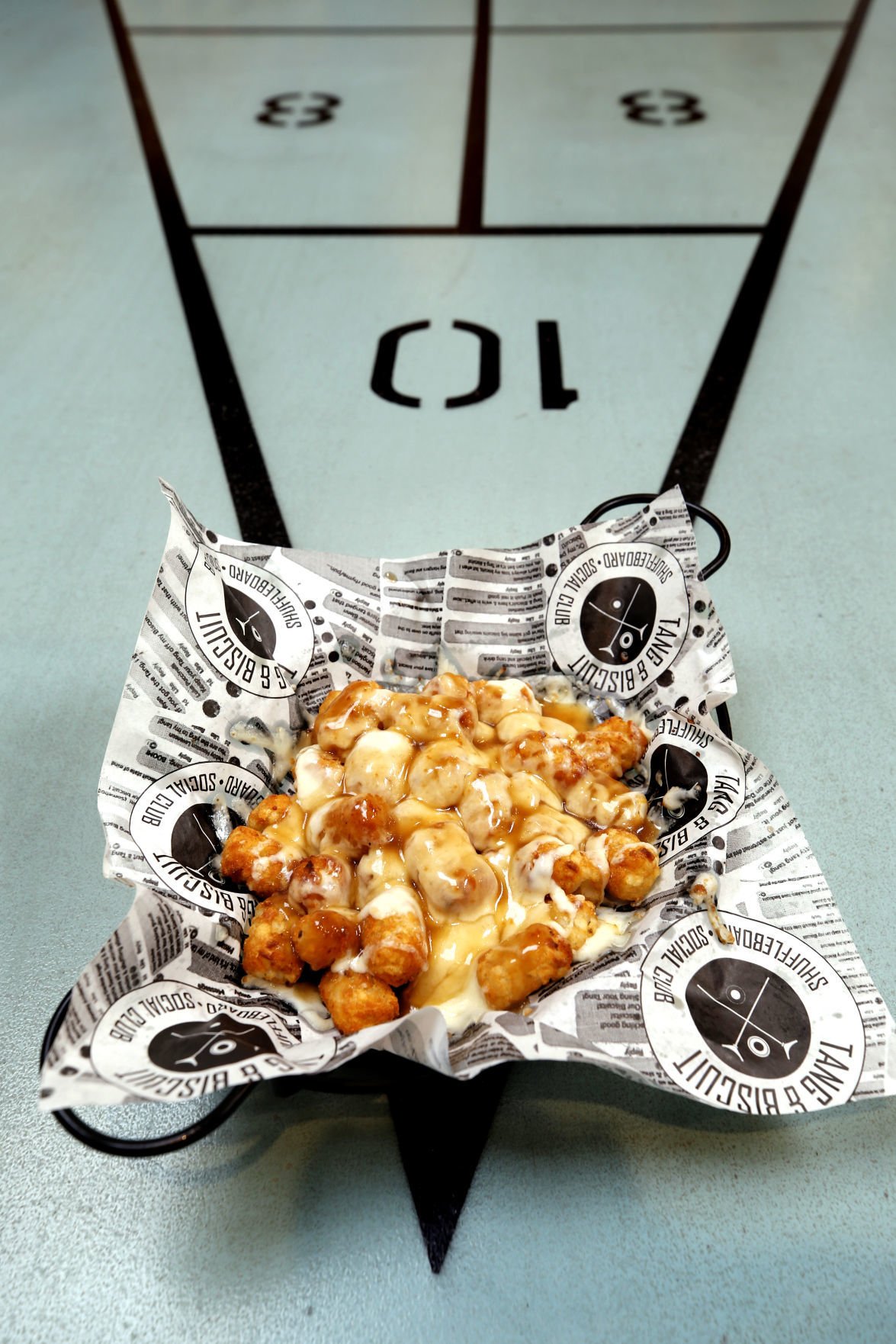 Restaurant review Tang & Biscuit serves biscuitbased menu with shuffleboard in Scott's