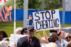 Activists gather outside the North Portico at the Florida Capitol to protest the proposed redistricting map Tuesday, April 28,