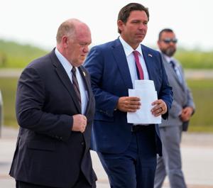 Governor Ron DeSantis walks with White House Border Czar Tom Homan as they hold a press conference at Alligator Alcatraz in