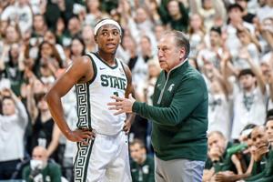 Michigan State Spartans coach Tom Izzo (right) talks with guard Jeremy Fears Jr. during an NCAA basketball game against the Colgate Raiders at Breslin Center in East Lansing, Michigan.