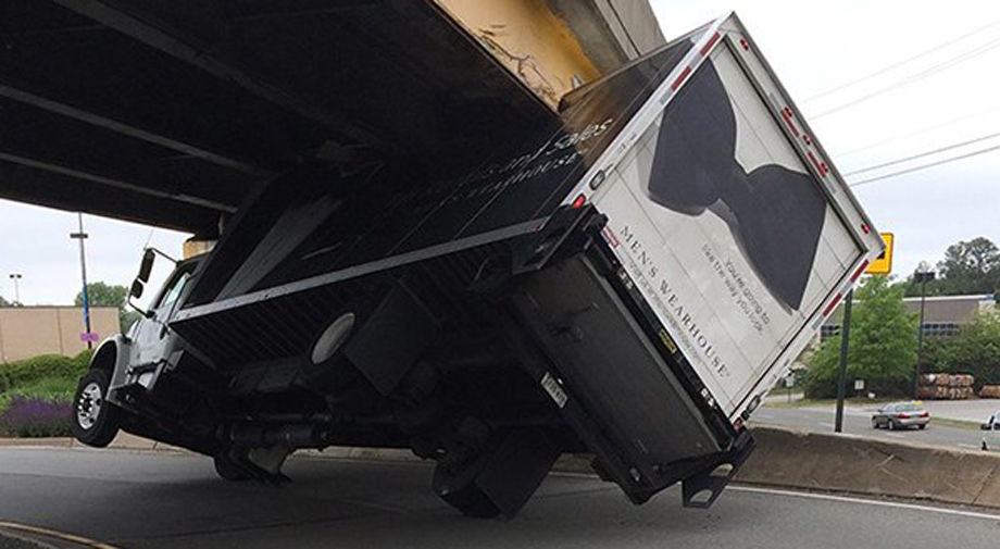 Driver charged after truck gets stuck under overpass at Regency Square