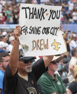 A fan holds up a sign for Drew Brees at the Pro Football Hall of Fame induction ceremony at the Pro Football Hall of Fame ,