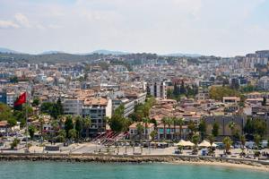 Kusadasi, Turkey - September 1, 2024: Panoramic view of Kusadasi, Turkey, a picturesque coastal town with a lively beach