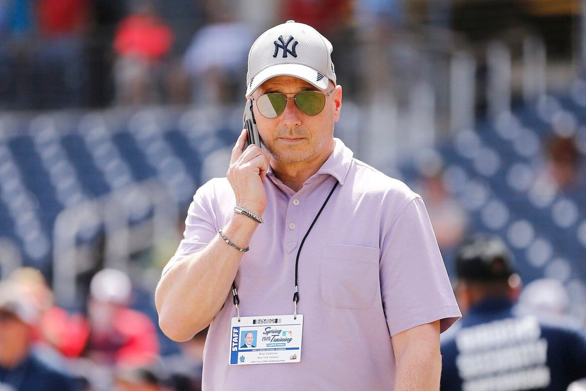 In this photo from March 12, 2020, New York Yankees general manager Brian Cashman talks on the phone prior to a Grapefruit League spring training game between the Washington Nationals and the New York Yankees at FITTEAM Ballpark of The Palm Beaches in W...