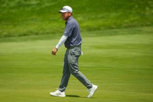 Charlie Wi walks across the eighth green during the first round of the U.S. Senior Open at Scioto Country Club in Columbus on