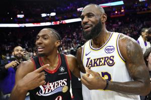 Los Angeles Lakers forward LeBron James and Philadelphia 76ers guard Tyrese Maxey react with each other after the game won by the Lakers at Xfinity Mobile Arena, Dec. 7, 2025 in Philadelphia.