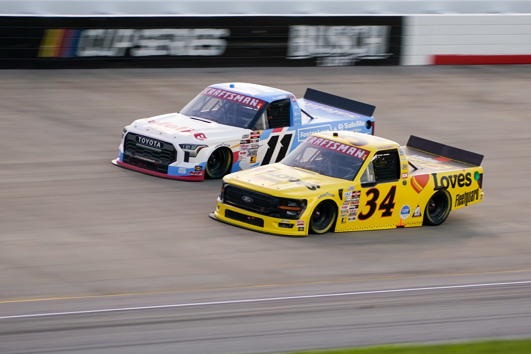 NASCAR Truck Series driver Corey Heim (11) and Layne Riggs (34) race ...