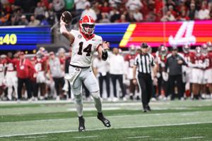 Georgia Bulldogs quarterback Gunner Stockton (14) throws a pass during the first quarter against the Alabama Crimson Tide during the 2025 SEC Championship game