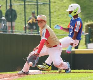Bryson Williams of Hamilton West Side, Ohio, (Great Lakes Region) is safe at third base before the throw to Hudson Cowley of