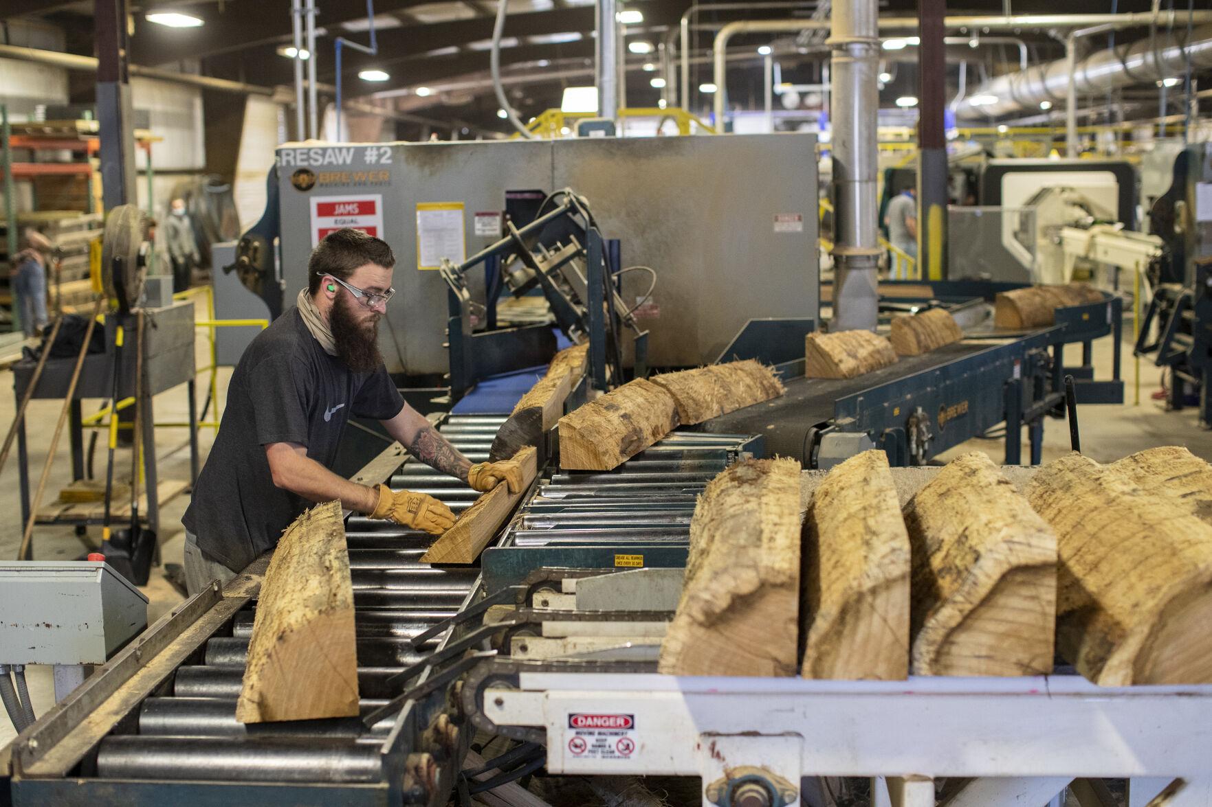 Workers take raw white oak logs and craft them into staves for 53- gallon barrels that will hold many world-famous bourbons at Robinson Stave Mill and East Bernstadt Cooperage in East Bernstadt, Kentucky, Sunday, Dec. 13, 2021. The staves are dried in t...