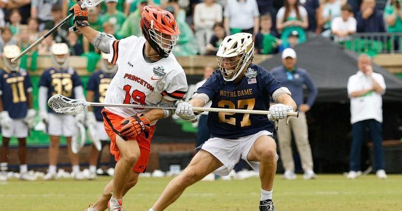 Princeton midfielder Tucker Wade (19) runs with the ball as Notre Dame defender Nate Schwitzenberg (27) defends during the 2026 NCAA men's lacrosse national title game at Scott Stadium in Charlottesville, Va.