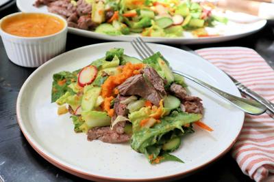 Quick-grilled skirt steak tops a spring salad of romaine, radish and cucumber dressed in a carrot-ginger vinaigrette.