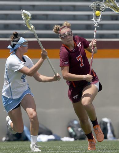 Virginia's Posey Valis (26) looks to pass while pursued by Duke's Stuart  Humphrey (13) and Claire Scarrone (19) during first half women's college  lacrosse action in the Atlantic Coast Conference tournament in