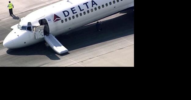 Delta passengers exit flight using jet slide after plane lands without gear extended