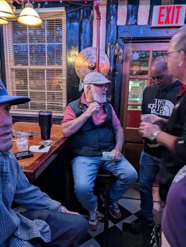 Carroll Bell collects covers at the door of The Coffee Pot