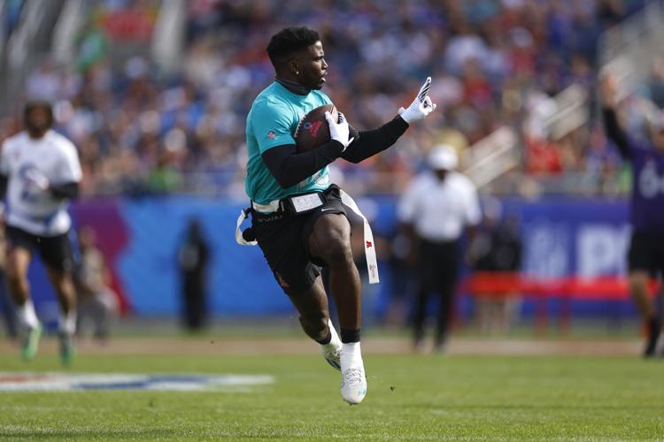 Tyreek Hill of the Miami Dolphins and AFC reacts as he runs the ball for a touchdown during the first quarter of the 2024 NFL Pro Bowl Games at Camping World Stadium on Feb. 4, 2024, in Orlando, Florida.