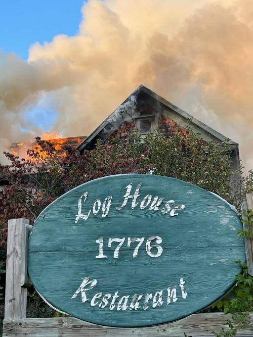 Log House fire with sign