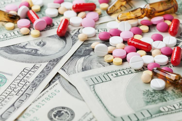 cost medicinal product and treatment concept, pills tablets with cash