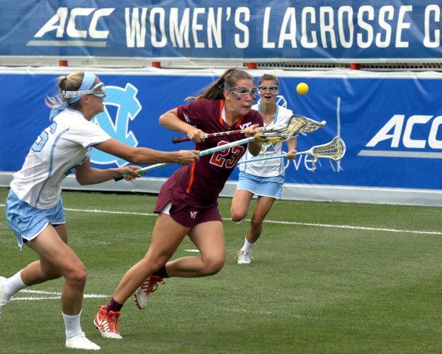 Virginia's Posey Valis (26) looks to pass while pursued by Duke's Stuart  Humphrey (13) and Claire Scarrone (19) during first half women's college  lacrosse action in the Atlantic Coast Conference tournament in