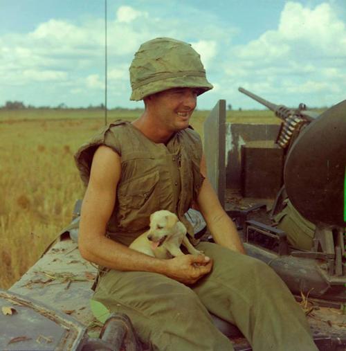 AP4 Jackie Coulter from Lafayette, GA holding a puppy that survived an earlier air strike. Very popular photo taken by Robert Lafoon.jpg