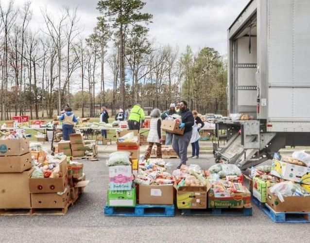 Volunteers help distribute free food Local News