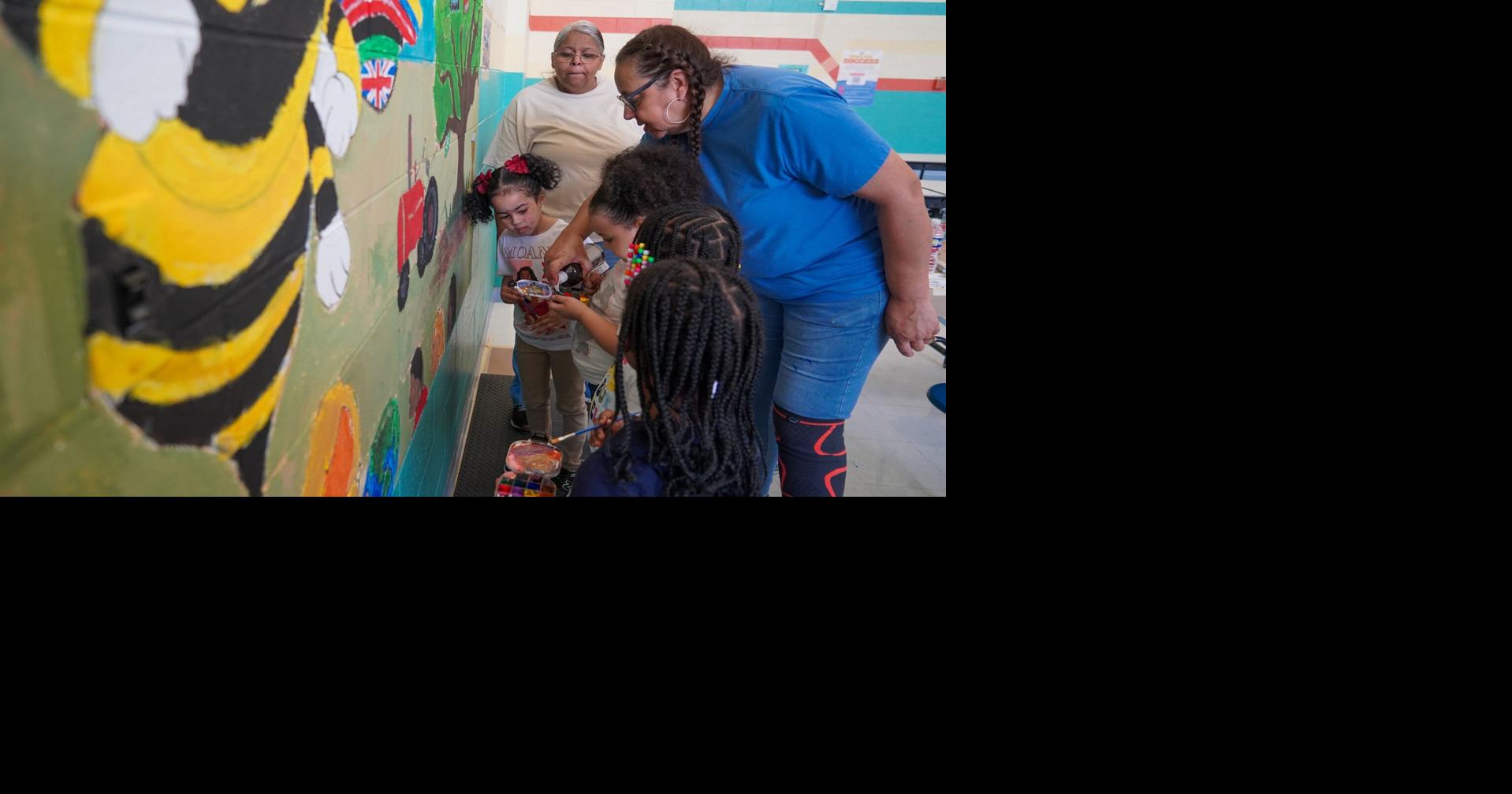 Students, local artist collaborate on mural reflecting global learning at Aurelian Springs