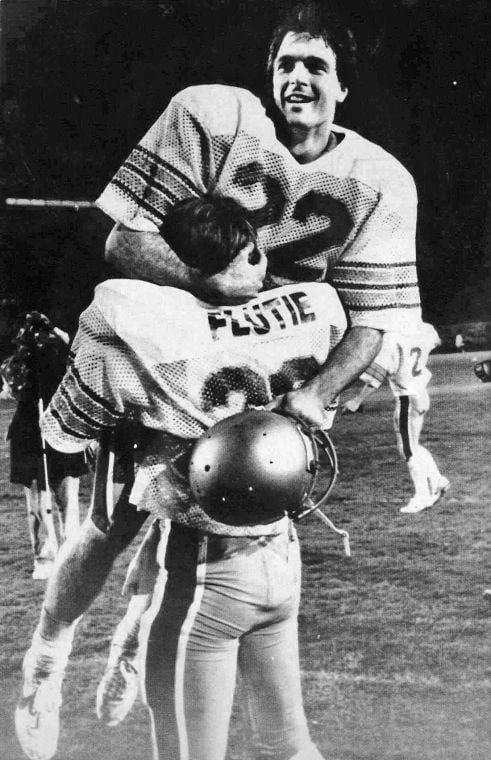 Boston College applications jumped about 30 percent in the two years after quarterback Doug Flutie, shown in his brother Darren’s arms, made the famous pass that gave the school a win over the Miami Hurricanes in November 1984. Associated Press file photo