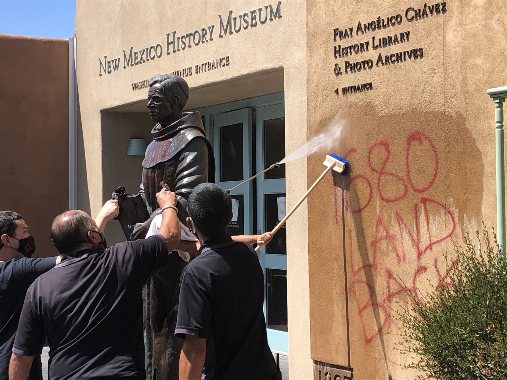 Graffiti marks up statue wall at New Mexico History Museum