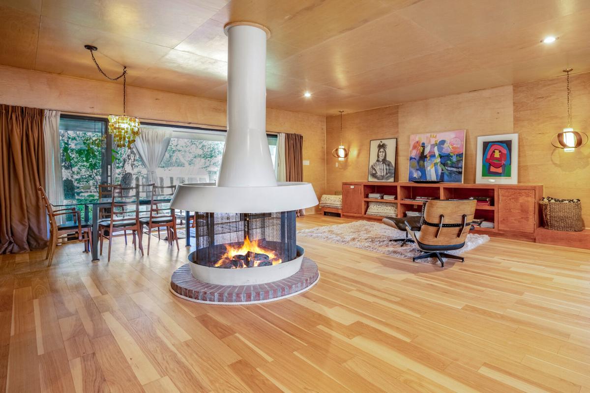 A freestanding mid-century design fireplace radiates modern chic in a Tesuque home.