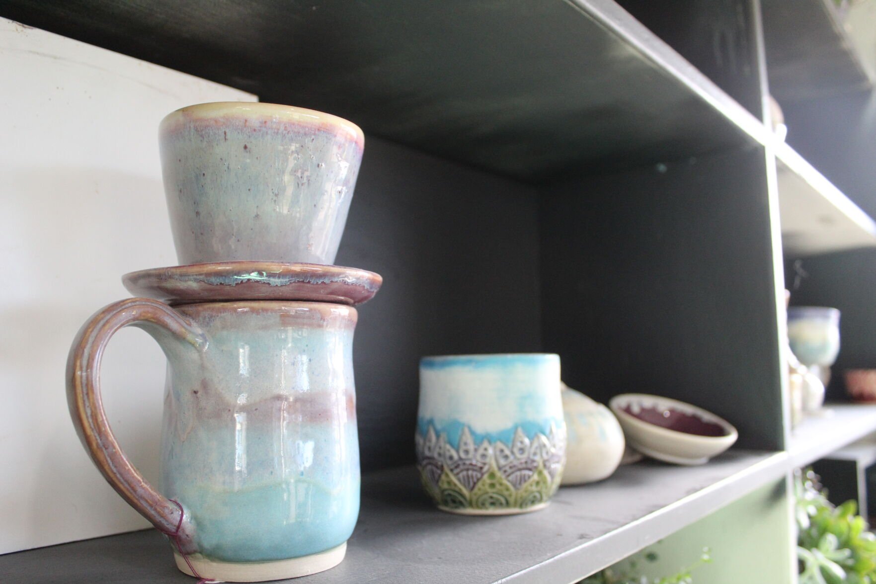 Pottery studio owner encourages creativity style Scene