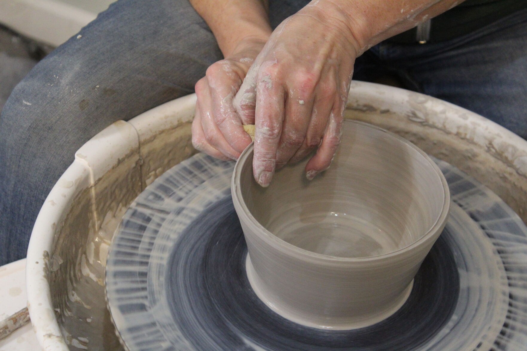 Pottery studio owner encourages creativity style Scene