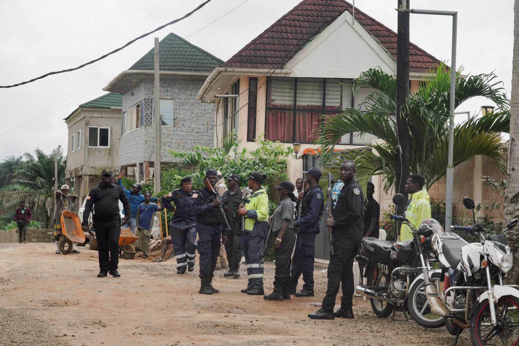 Deportees from the United States arrive in Liberia; security guards stand outside a building near Roberts International Airport