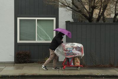 Man in rain with shopping cart
